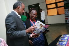 Aasif-Karim-and-Occidental-insurance-general-manager-Agatha-Solitei-peruse-the-sports-monthly-magazine