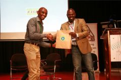 David-Thuo-receives-gift-hamper-from-Wilfred-Bungei-after-delivering-his-speech-on-recreational-running