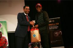 Extreme-sports-CEO-Hussein-Mohammed-recieves-a-gift-hamper-from-KISFF-Brand-ambassador-Douglas-Wakiihuri-after-the-panel-on-football-in-Kenya-4