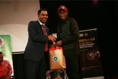 Extreme-sports-CEO-Hussein-Mohammed-recieves-a-gift-hamper-from-KISFF-Brand-ambassador-Douglas-Wakiihuri-after-the-panel-on-football-in-Kenya-4