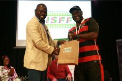 Wilfred-Bungei-receives-a-gift-hamper-from-Edward-Rombo-after-the-panel-session-on-future-of-sports-in-Kenya-at-the-global-stage