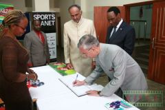 H.E.-Mr.-Rahul-Chhabra-High-Commissioner-of-India-to-Kenya-signs-the-visitors-book-as-Aasif-Karim-and-Dr.-Ezekiel-Mutua-look-on-during-the-KISFF2019-awards-gala-2