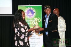 Kerubo Momany receives a trophy from Douglas Wakiihuri for the best short film Half Blood from France